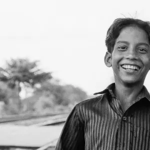 Boy smiling at railroad crossing