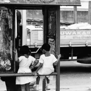 Little girls at bus stop