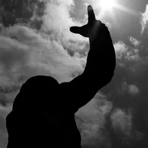 Peace statue pointing at sky