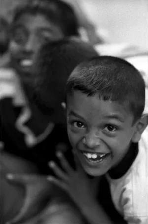 Boy standing happily in front of camera