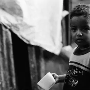 Boy gazing with mug in his hand