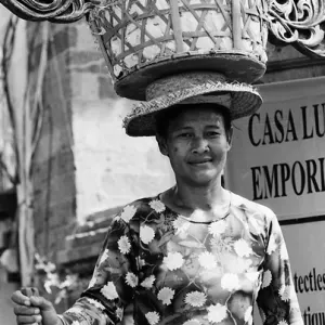 Woman putting big basket on head