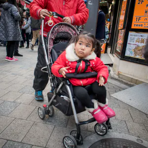 Little girl on a baby buggy