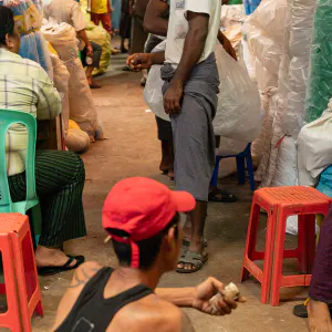 Men lolling about in market