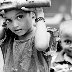 Girl and boy at well