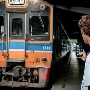 Man making a video of Maeklong Railway