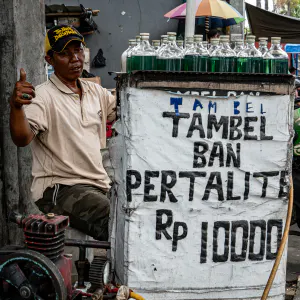 Man selling green liquid