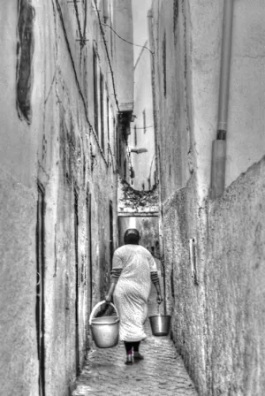 Woman carrying two buckets