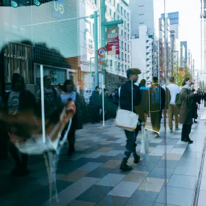 The streetscape of Ginza reflected in the glass of the NISSAN CROSSING