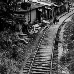 Figures walking on railway track