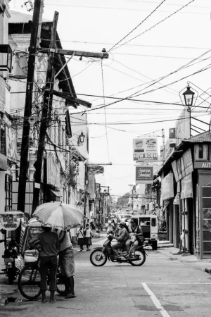 Two persons standing under same umbrella