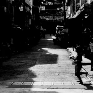 Silhouetted woman crossing street