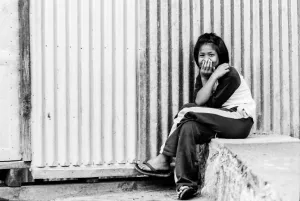 Cross-legged girl waiting for bus