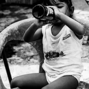 Little girl taking a swig of juice