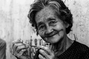 Older woman holding spoon