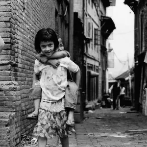 Girl carrying brother piggyback