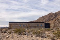 morning dove by homestead in Twentynine palms modern view of rammed earth house exterior in a desert context