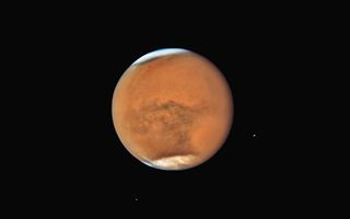 The Hubble Space Telescope captured this crystal-clear view of Mars and its two moons Phobos and Deimos in mid-July, when a massive dust storm was still raging across the planet's surface. Today, the Red Planet will reach opposition, when it is on the opposite side of Earth as the sun. Mars will make its closest approach to Earth since 2003 on Tuesday (July 31). 