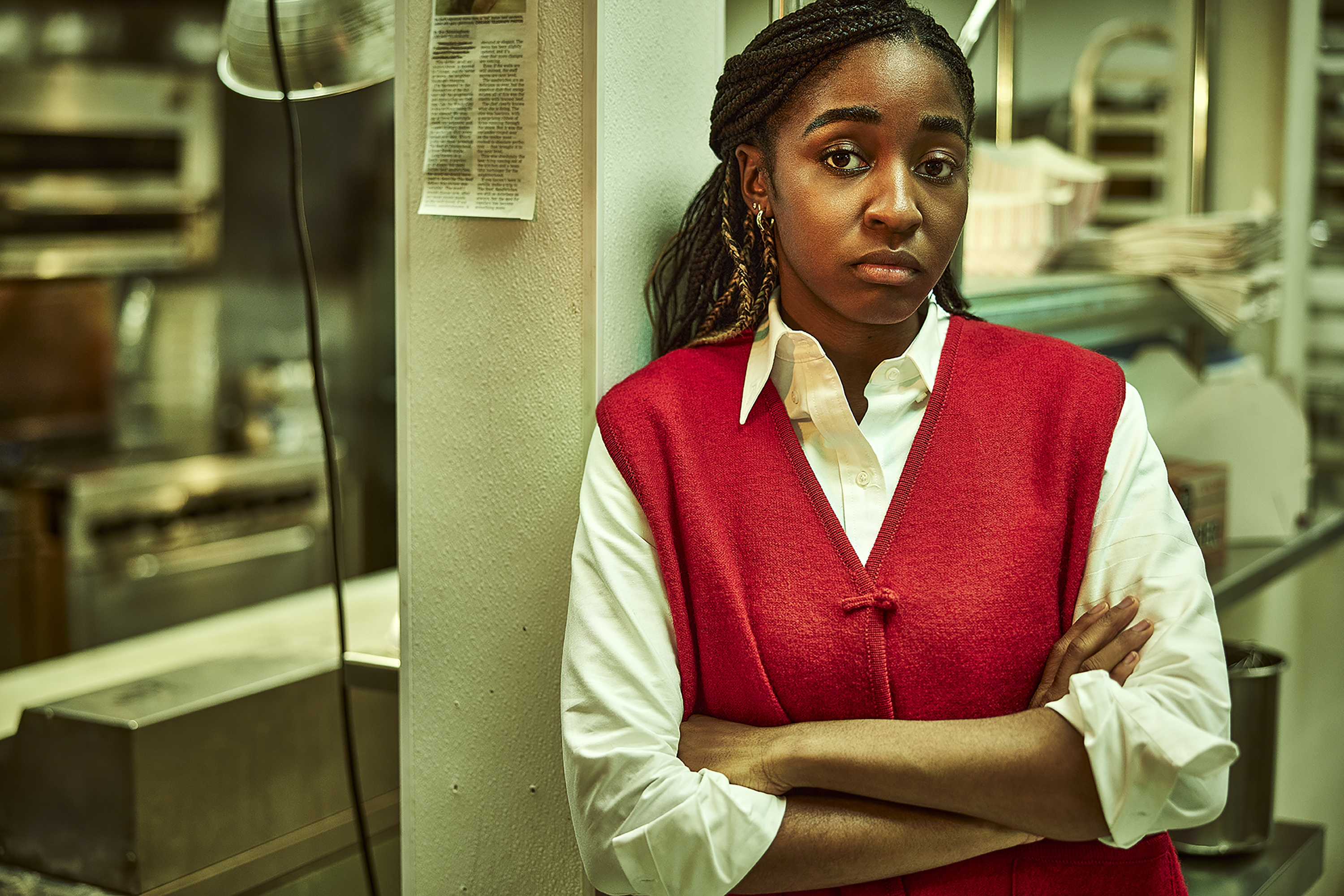 Syd from The Bear with a red sweater vest.