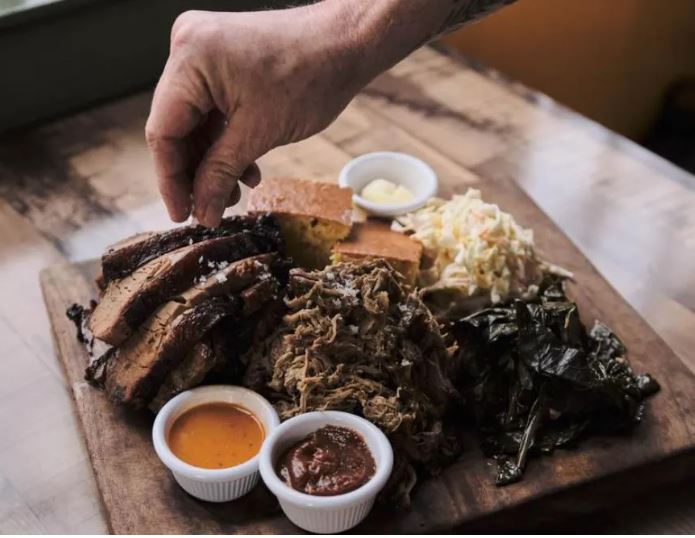 A spread of barbecue, cornbread, macaroni, and sauces at Buckshot.