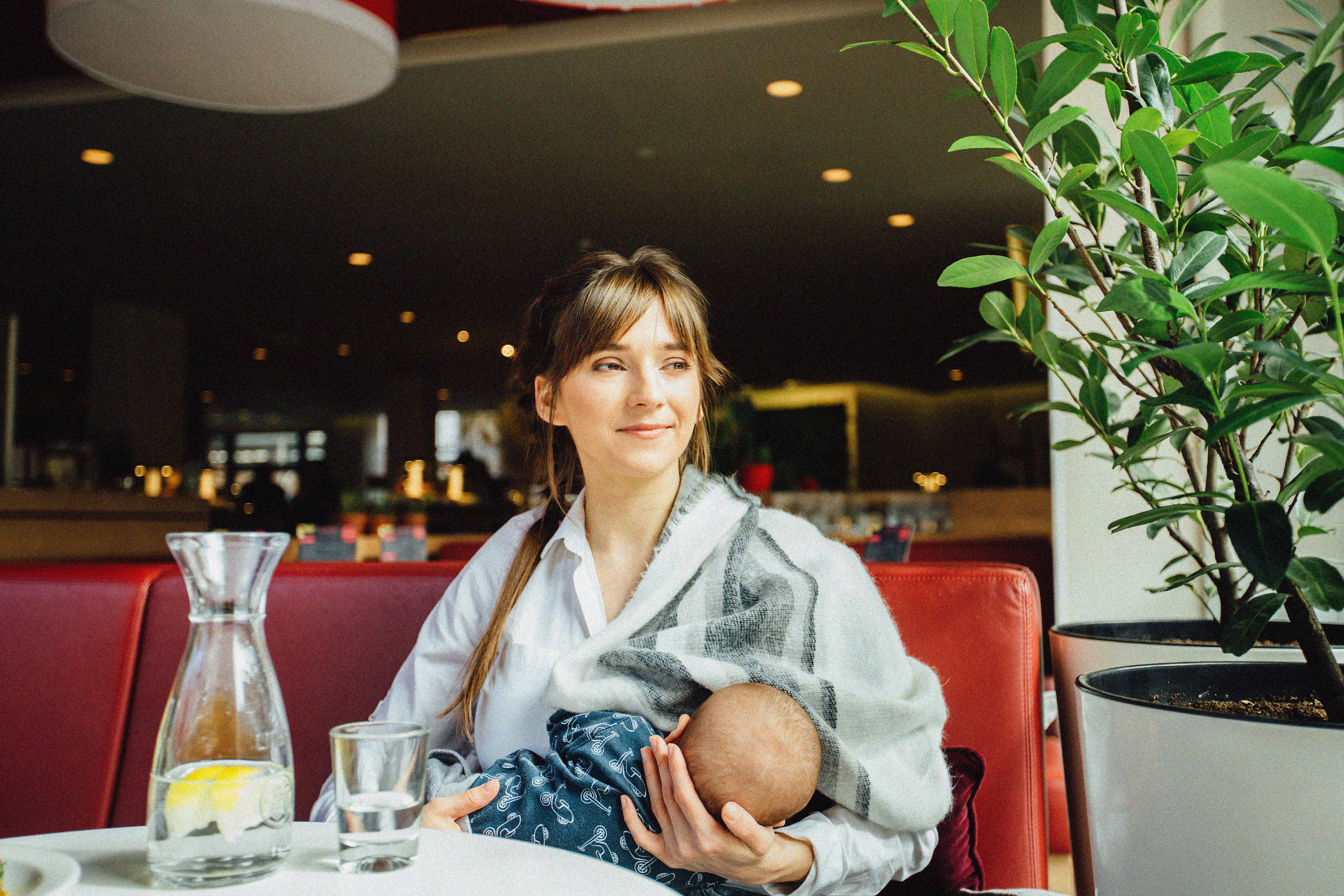 An image of a woman breastfeeding in a restaurant