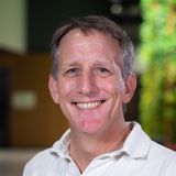 A smiling photo of Paul from the shoulders up. He is wearing a light colored polo shirt.