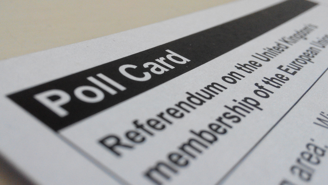 [IMAGE] Close up of a polling card for the UK referendum on leaving the EU. In the foreground, it reads "Poll Card" in white letters on a black background.