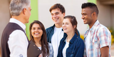 High school students talking to a teacher