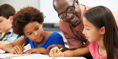 Teacher helping students