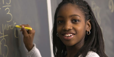 Student in front of a black board