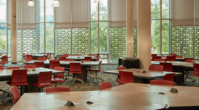 Study at McMaster - McMaster Mills Learning Commons - Empty McMaster study room with collaborative desks and red chairs