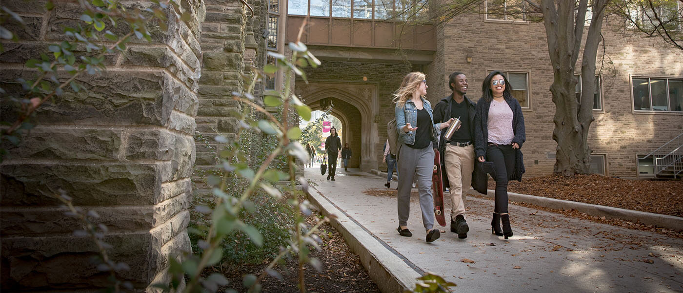 Three McMaster students walking through McMaster campus