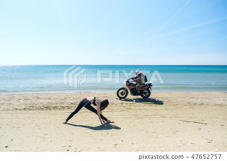 Caucasian woman practicing yoga at black sea 47652757