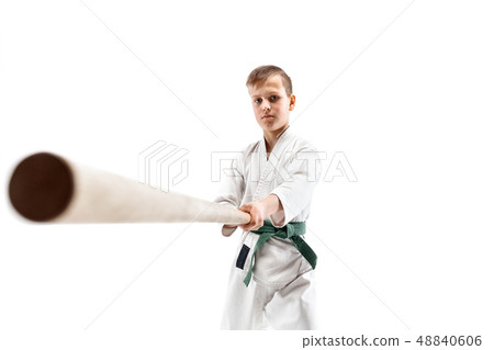 Teen boy fighting with wooden sword at Aikido training in martial arts school 48840606