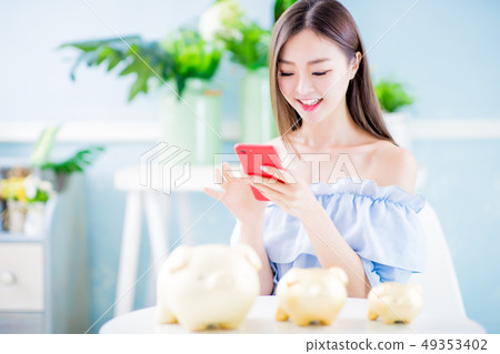 Happy woman with piggy bank 49353402