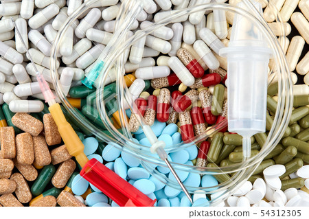 Intravenous therapy drip and many colorful pills 54312305