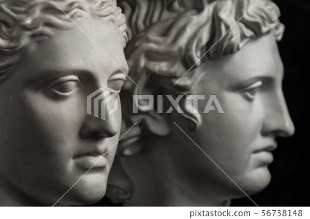 Gypsum copy of ancient statue Apollo and Diana head on dark textured background. Plaster sculpture 56738148