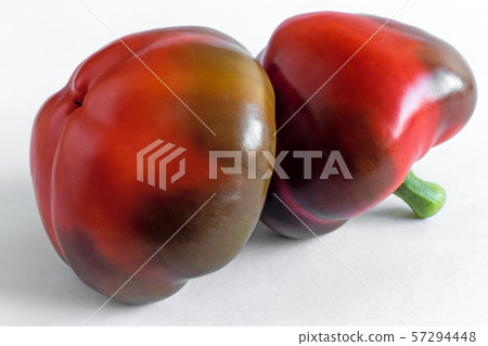 Two red peppers isolated on white background. 57294448