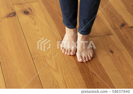 Wood floor and young woman's feet up 58637840