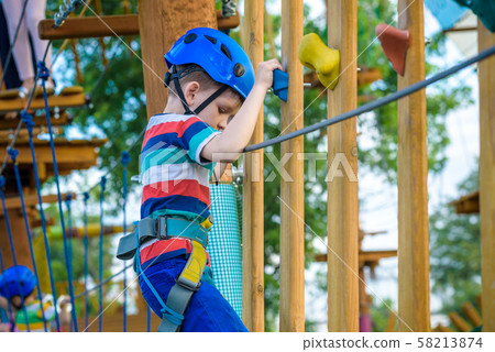 happy boy on the zip line. proud of his courage 58213874