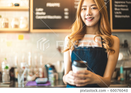 Portrait young Asian woman barista feeling happy 60076048