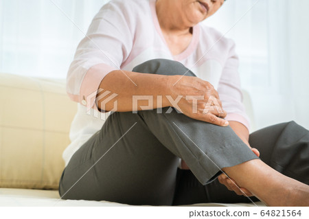 leg pain of senior woman at home, healthcare problem of senior concept 64821564