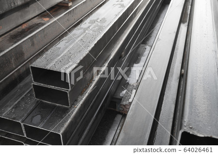 Stack of rolled metal products, gray steel pipes 64026461