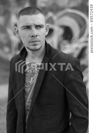 Portrait of a bully man in a jacket. Black and white photo 69572439