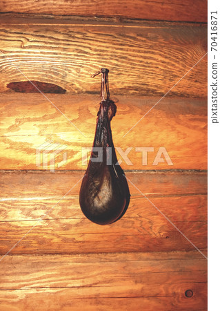 Gall bladder of a bear while drying on a log wall 70416871