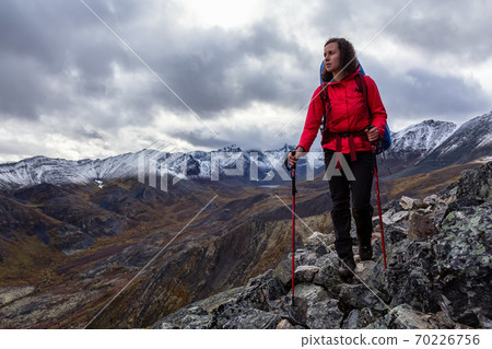 Girl Backpacking along Scenic Hiking Trail 70226756