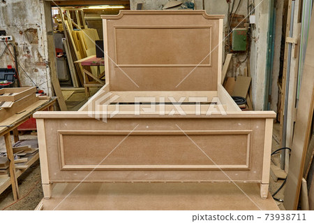 Joinery. Bed building process. Wooden furniture manufacturing process. Furniture manufacture. Close-up 73938711