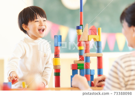 Little boy playing with blocks 73388098