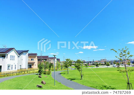 A residential area and a park in blue sky 74787269