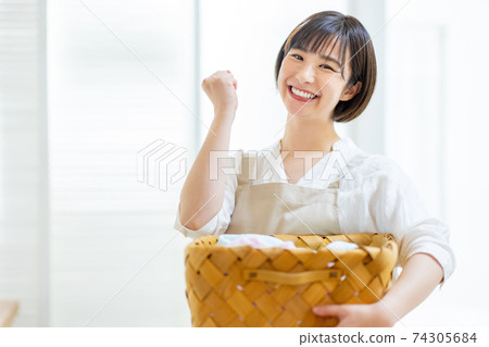 A young lady doing the laundry 74305684